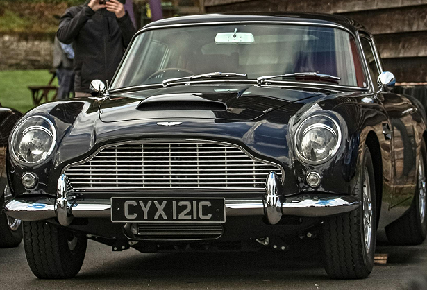 Classic black vintage car with chrome details and a CYX 121C license plate, parked outdoors.